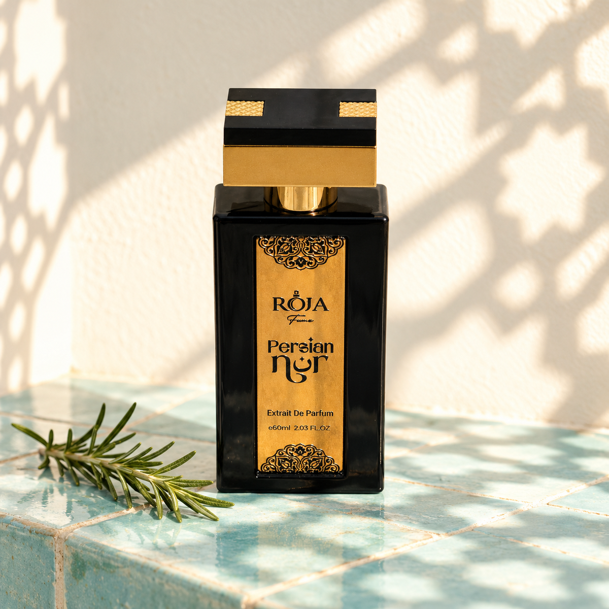 Roja Fume Persian Nur Extrait de Parfum with a rosemary sprig in sunlight