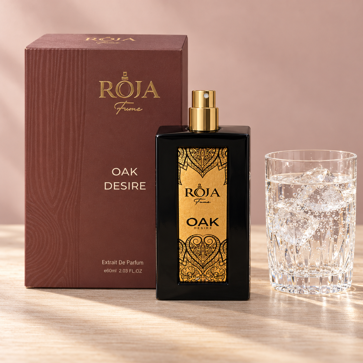 Roja Fume Oak Desire Extrait de Parfum with its box and a glass of sparkling water