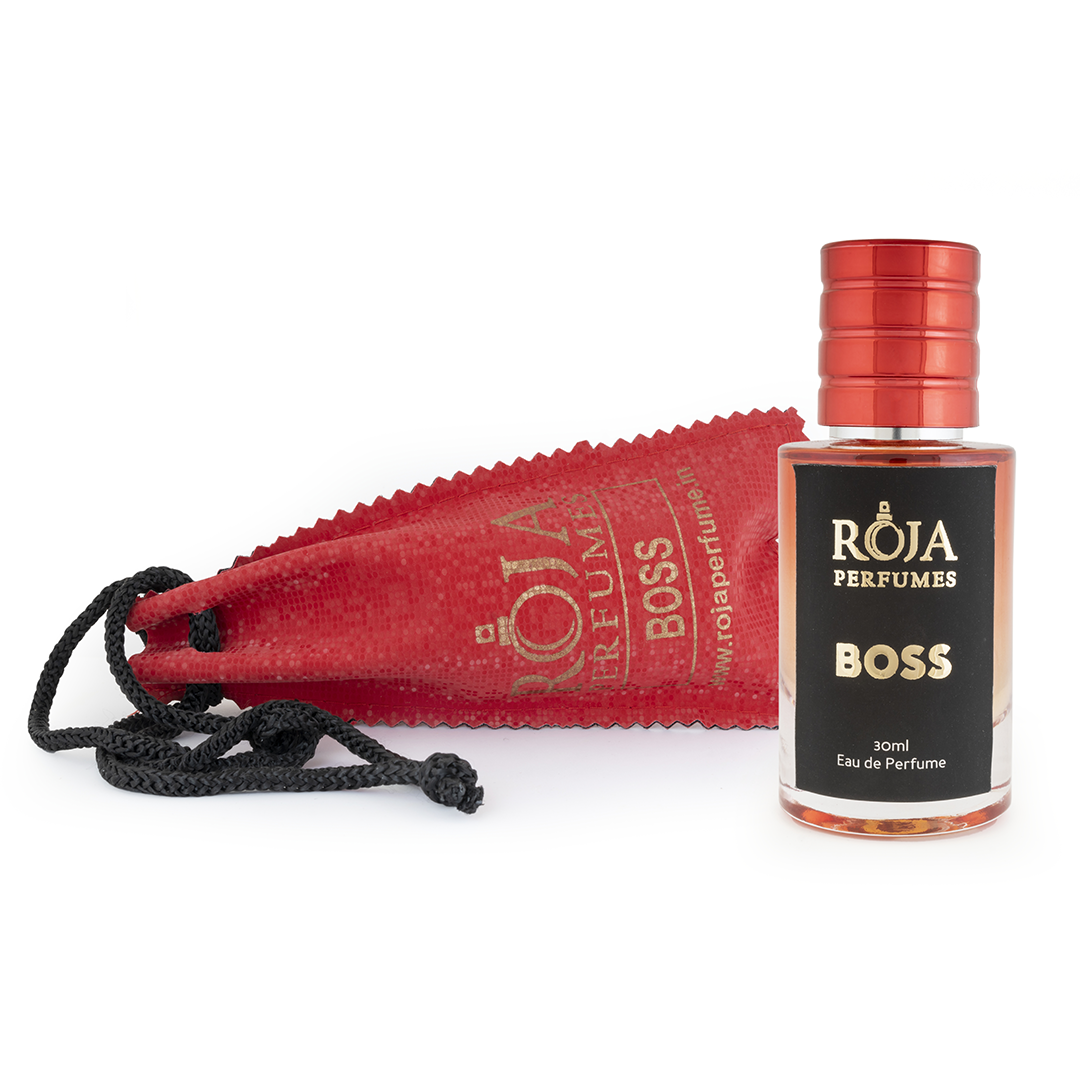 Roja Fume Boss perfume bottle lying on its velvet pouch